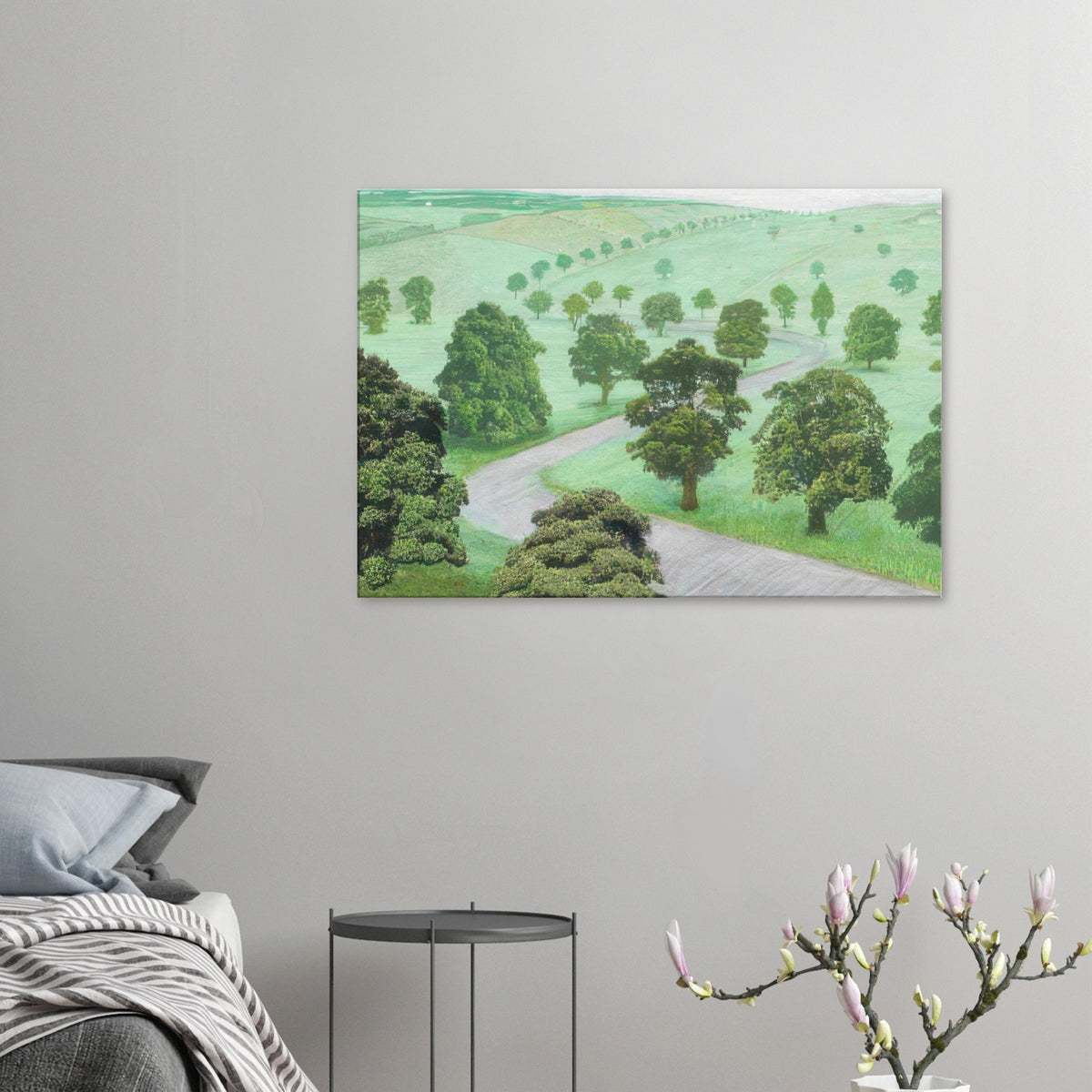 David Hockney canvas print of Green Valley, showing open fields, flowering trees and a winding road in soft, misty colours.